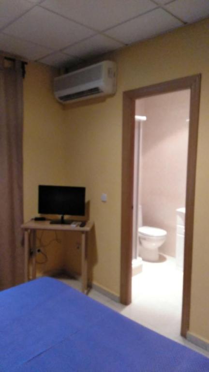 Postel nebo postele na pokoji v ubytování Hostal DS