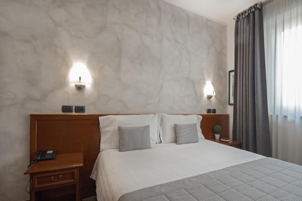 Postel nebo postele na pokoji v ubytování Hotel Medea