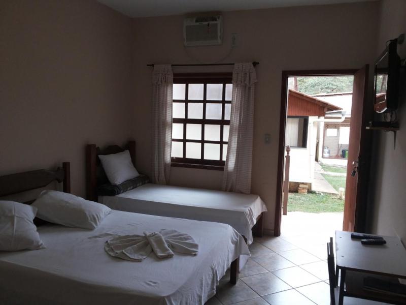 A bed or beds in a room at Pousada Clube Santa Cruz