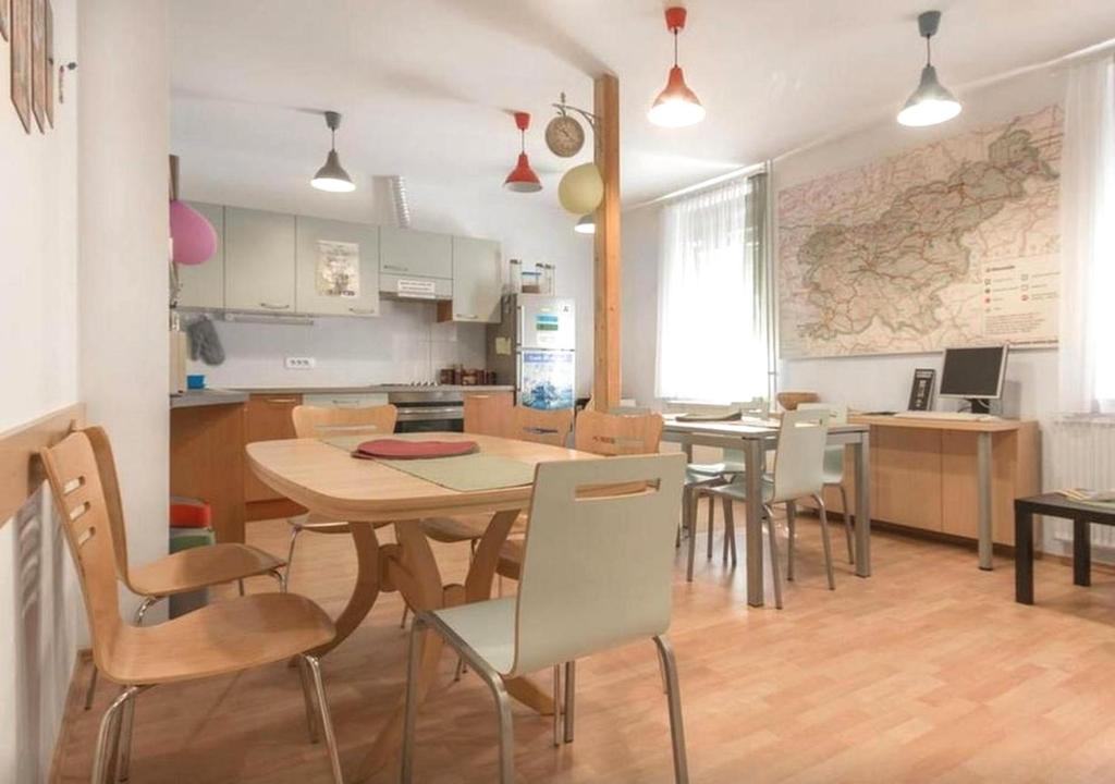 - une cuisine et une salle à manger avec une table et des chaises dans l'établissement Hostel Vrba, à Ljubljana