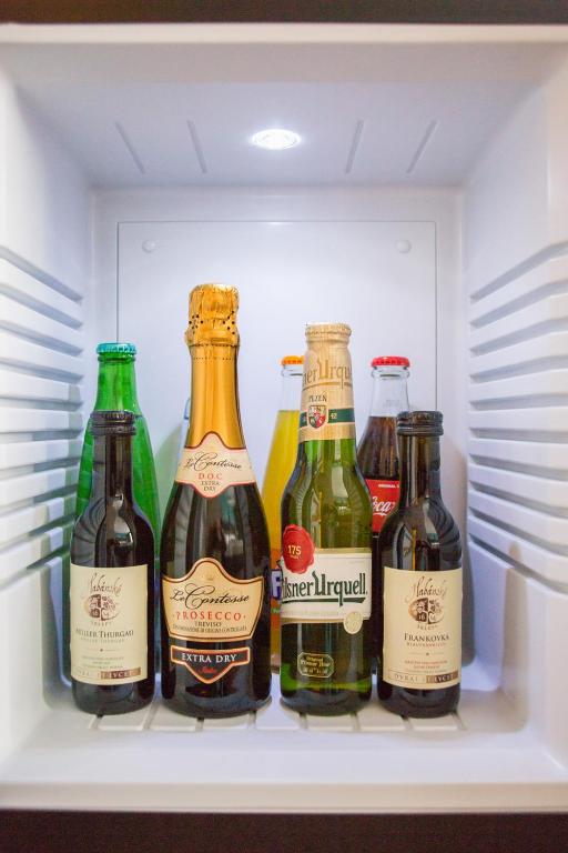 a refrigerator filled with different types of bottles of beer at Hotel Galatea in Mladá Boleslav