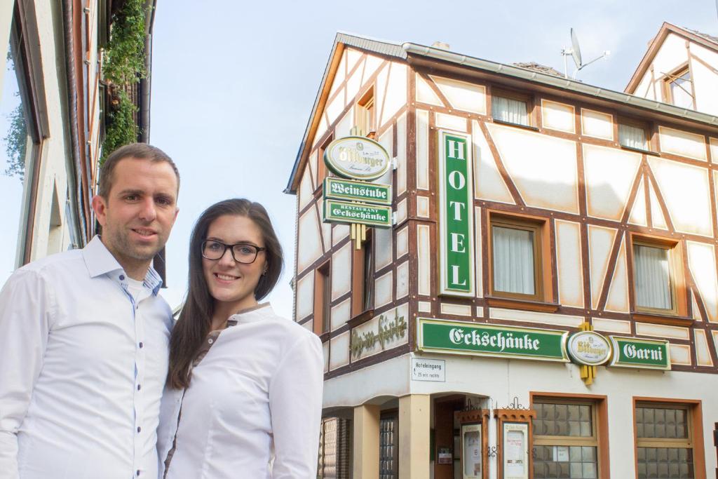 a man and a woman standing in front of a building at Hotel Garni Eckschänke in Bad Neuenahr-Ahrweiler