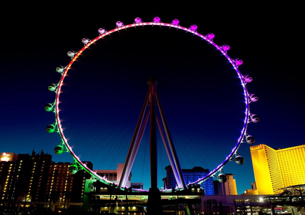 a ferris wheel at night in a city at The LINQ Hotel and Casino in Las Vegas