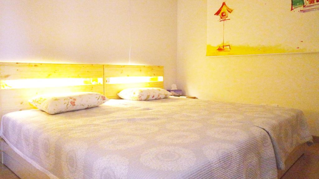 a bedroom with a large white bed with two pillows at Comfortable as your home - JS1 in Seoul