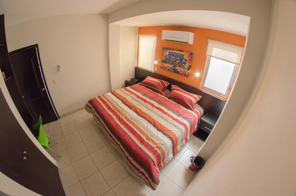 Postel nebo postele na pokoji v ubytování Hotel Belisario INN
