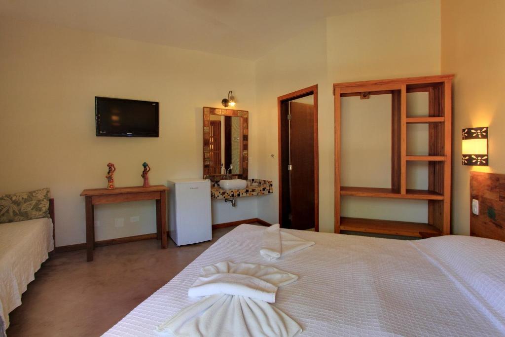 Cama ou camas em um quarto em Pousada Tupinamba