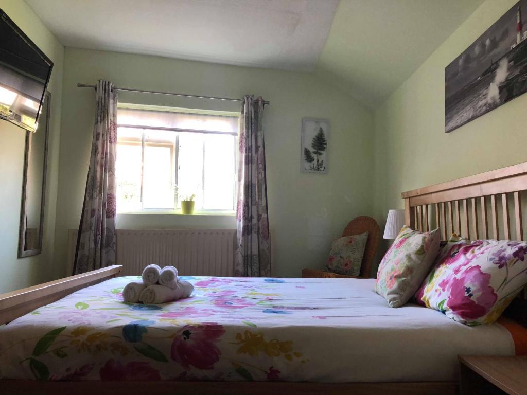 a bedroom with a bed with a stuffed animal on it at Reindeer Accomodation in Southwell