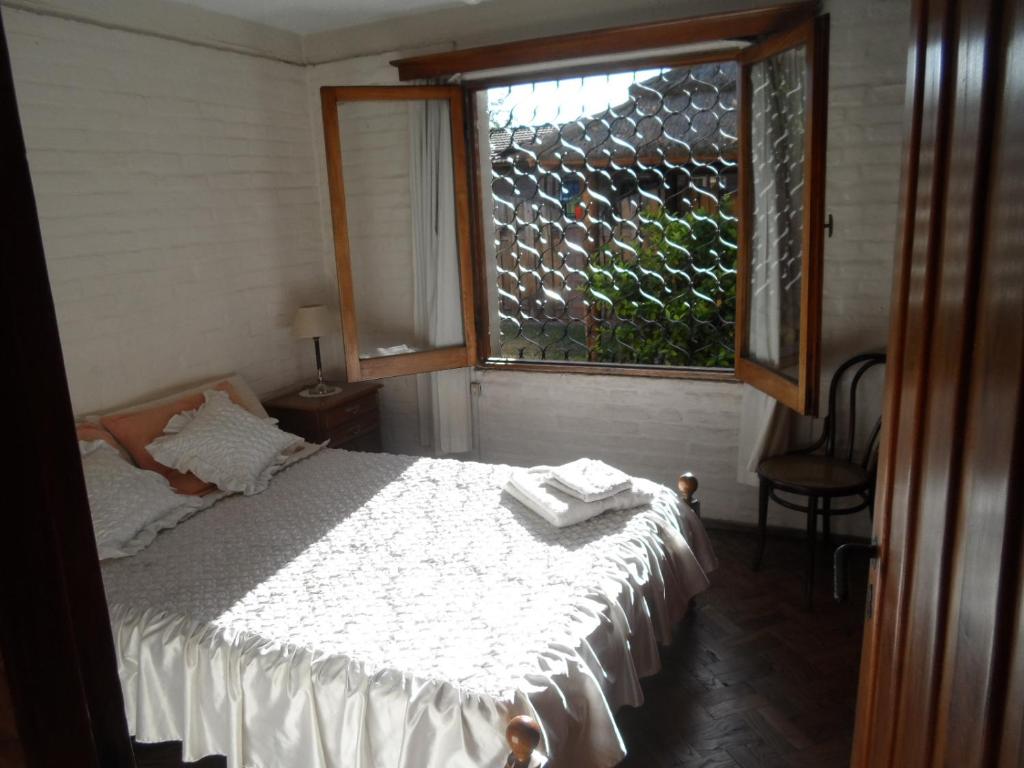 a bedroom with a white bed and a window at Turística San José in Mendoza