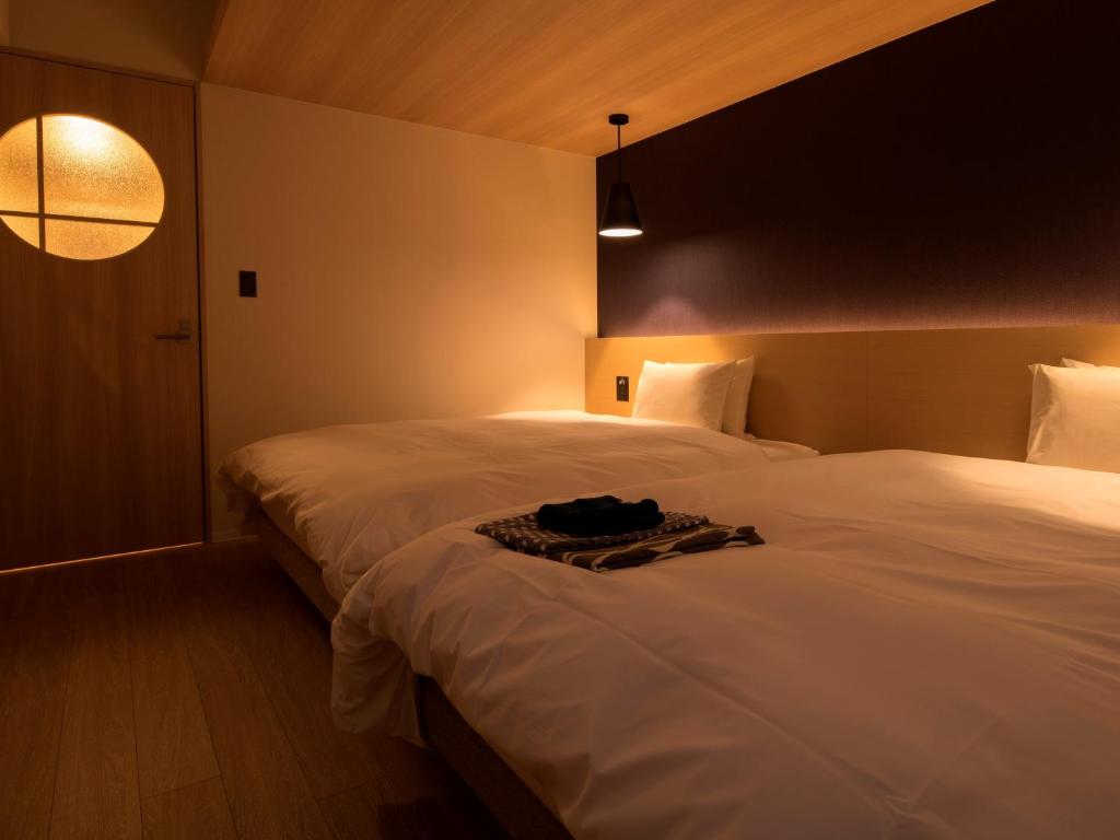 Postel nebo postele na pokoji v ubytování UAN kanazawa