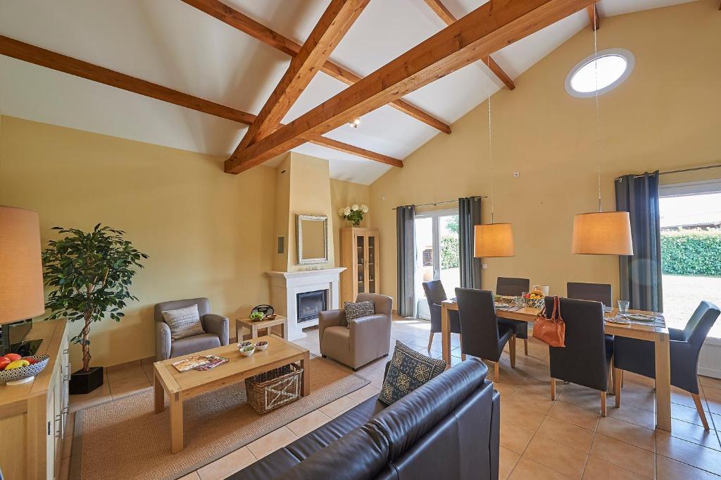 a living room with a couch and a table at Domaine les Forges in Les Forges