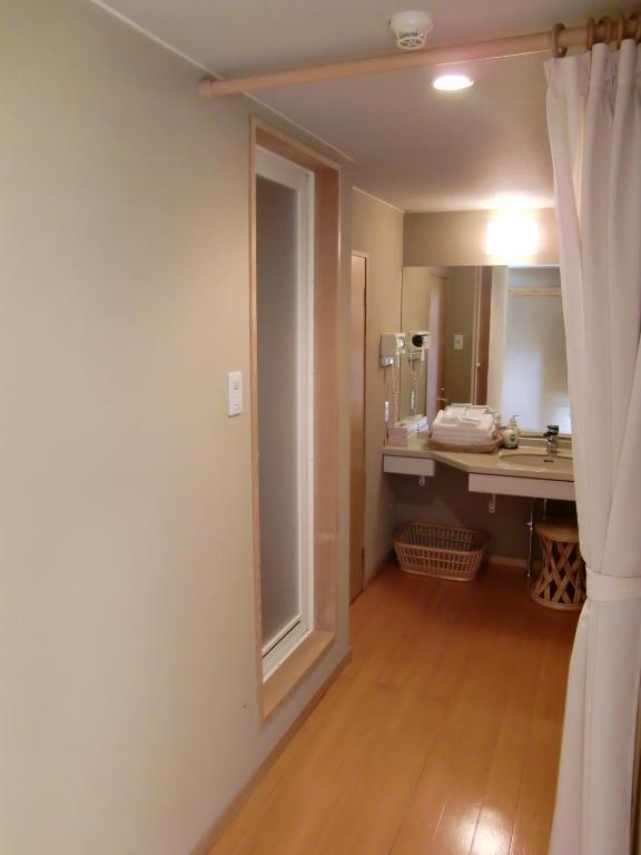 Postel nebo postele na pokoji v ubytování Hakuba Hotel Ougiya