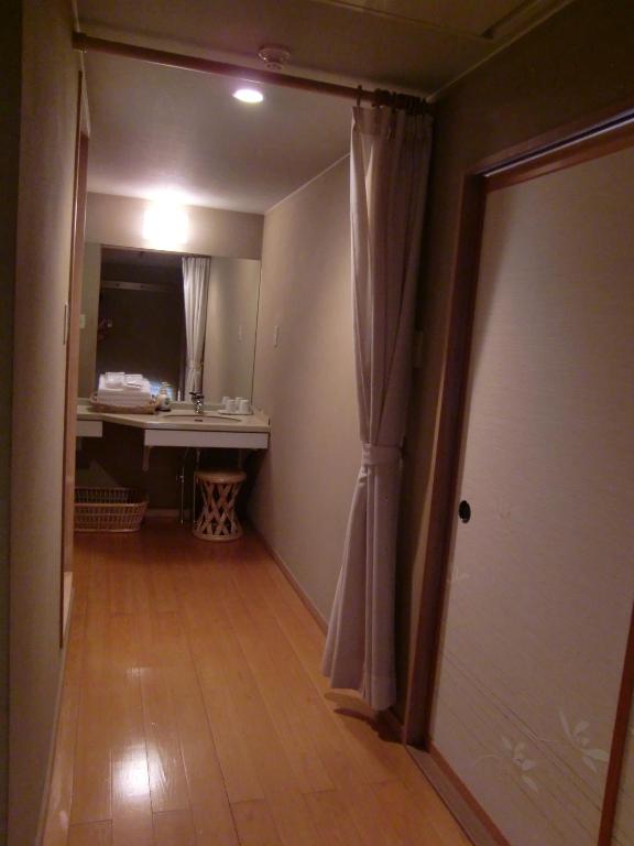 Postel nebo postele na pokoji v ubytování Hakuba Hotel Ougiya