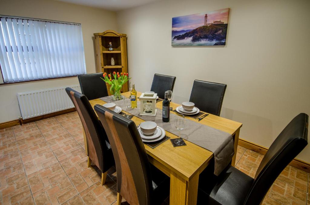 a dining room with a table and chairs at fairhill holiday let in Ballycastle