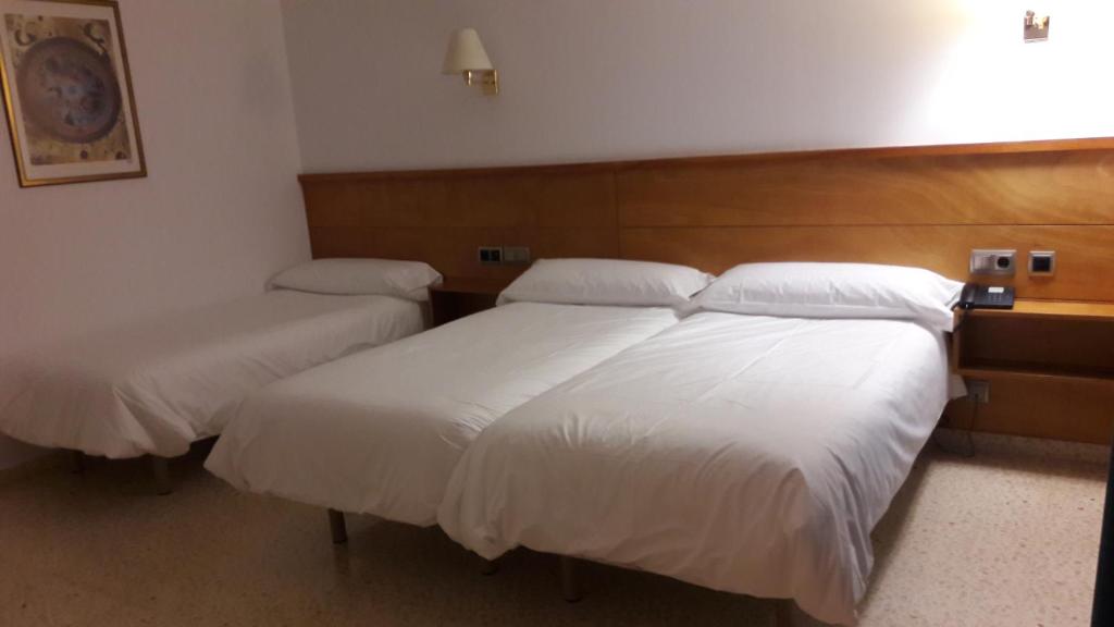 Postel nebo postele na pokoji v ubytování Hotel Octavia