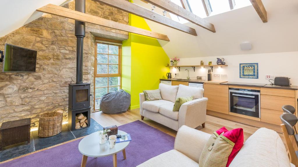 a living room with a couch and a fireplace at Hayloft Edinburgh in Edinburgh