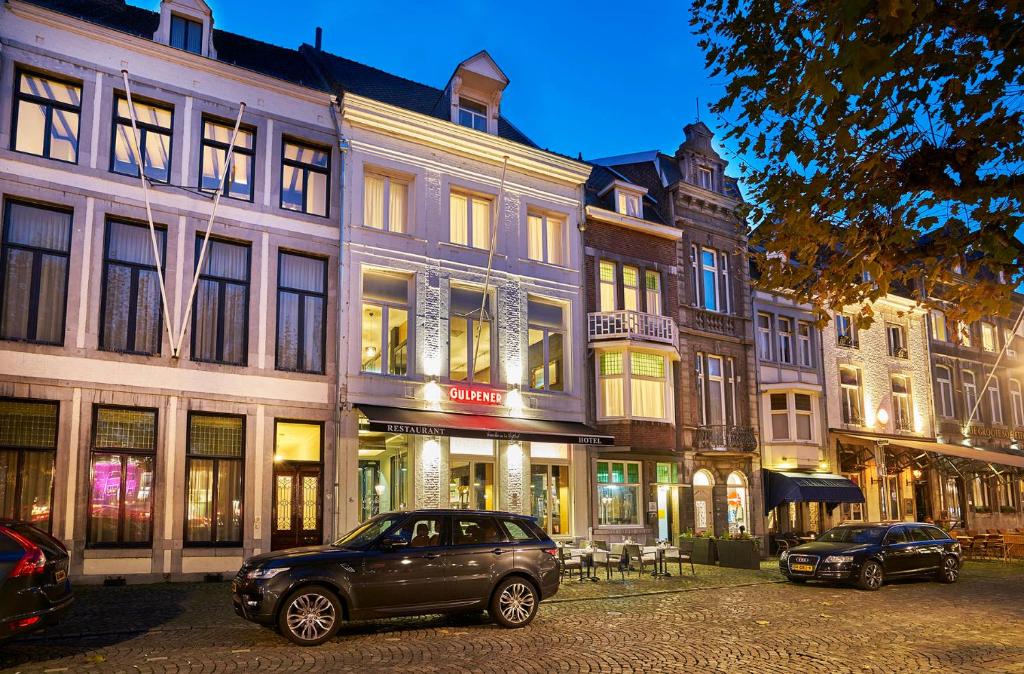 a car parked in front of buildings on a street at Saillant Hotel Maastricht City Centre - Auping Hotel Partner in Maastricht