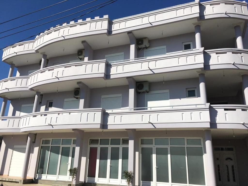 a white building with windows on the side of it at Apartments Flamida in Ulcinj