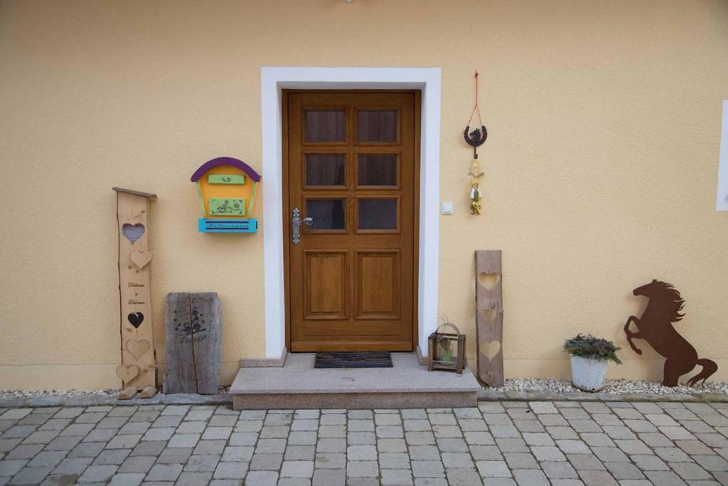 a front door of a house with a horse on it at Talblickhof in Waldmünchen
