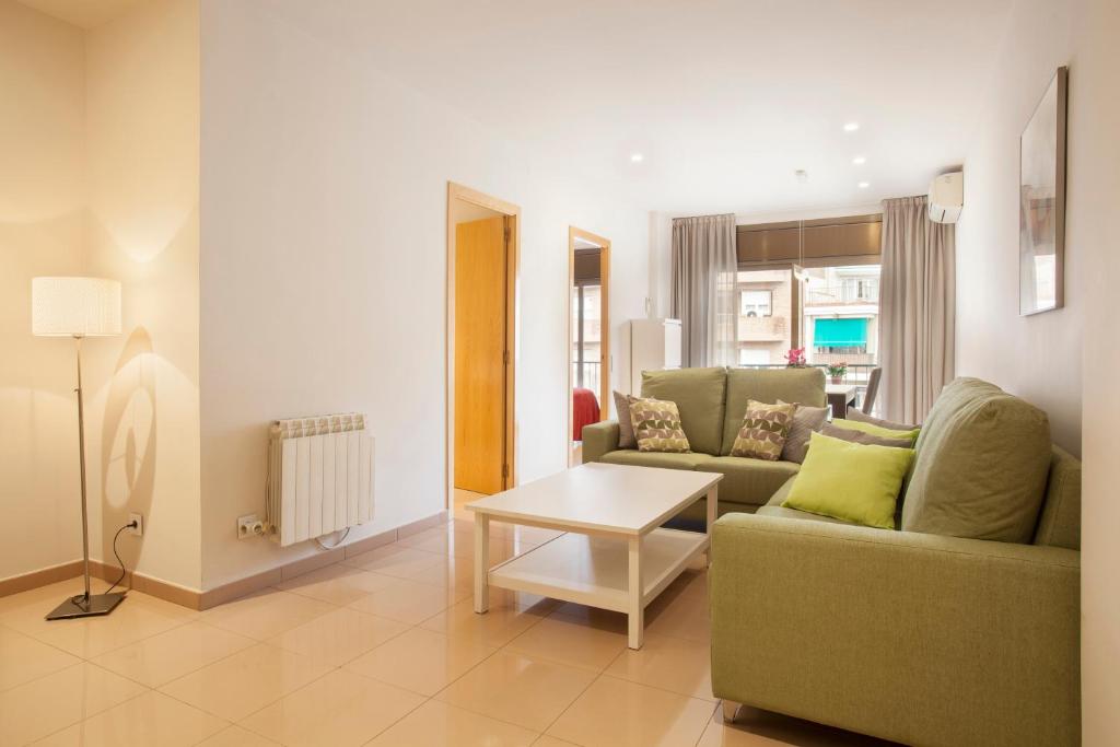 a living room with a couch and a table at Rosselló Apartment in Barcelona