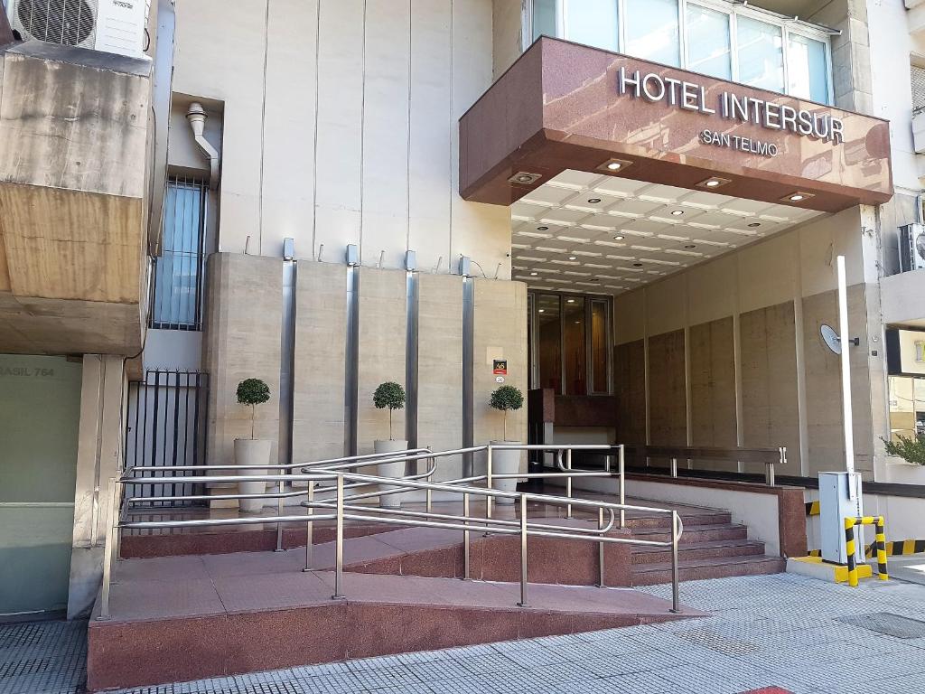 a hotel entrance with stairs in front of a building at Hotel Intersur San Telmo in Buenos Aires