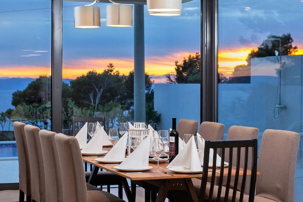 a wooden table with white napkins on it in a restaurant at Villa Sima in Makarska
