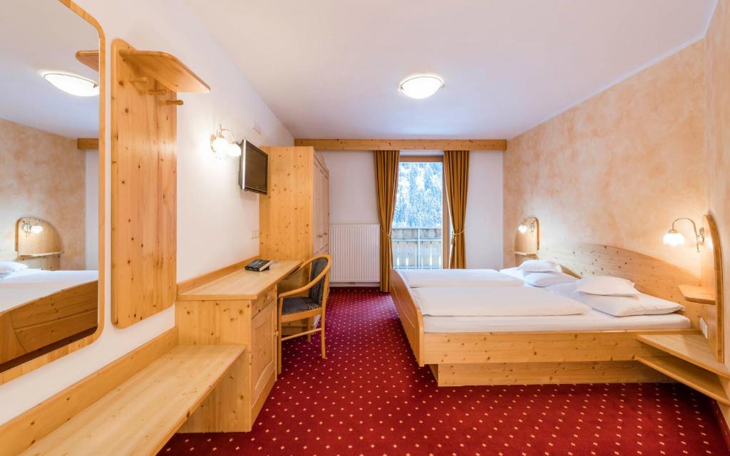 Postel nebo postele na pokoji v ubytování B&B Hotel Alpenrose Rooms & Apartments