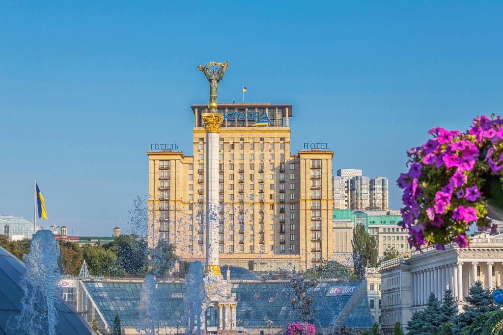 a tall building with a clock on top of it at Ukraine Hotel in Kyiv