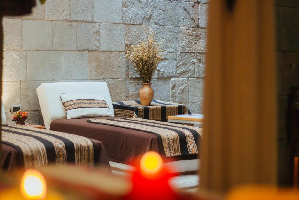 Postel nebo postele na pokoji v ubytování Xima Exclusive Cusco
