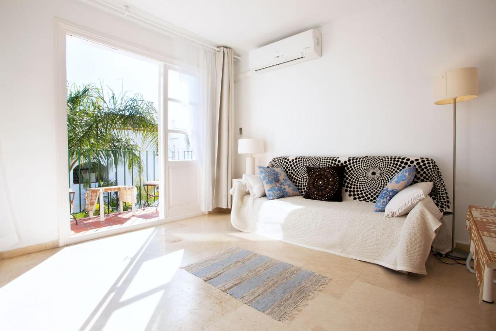 a living room with a couch and a large window at Benavista Studio in Estepona