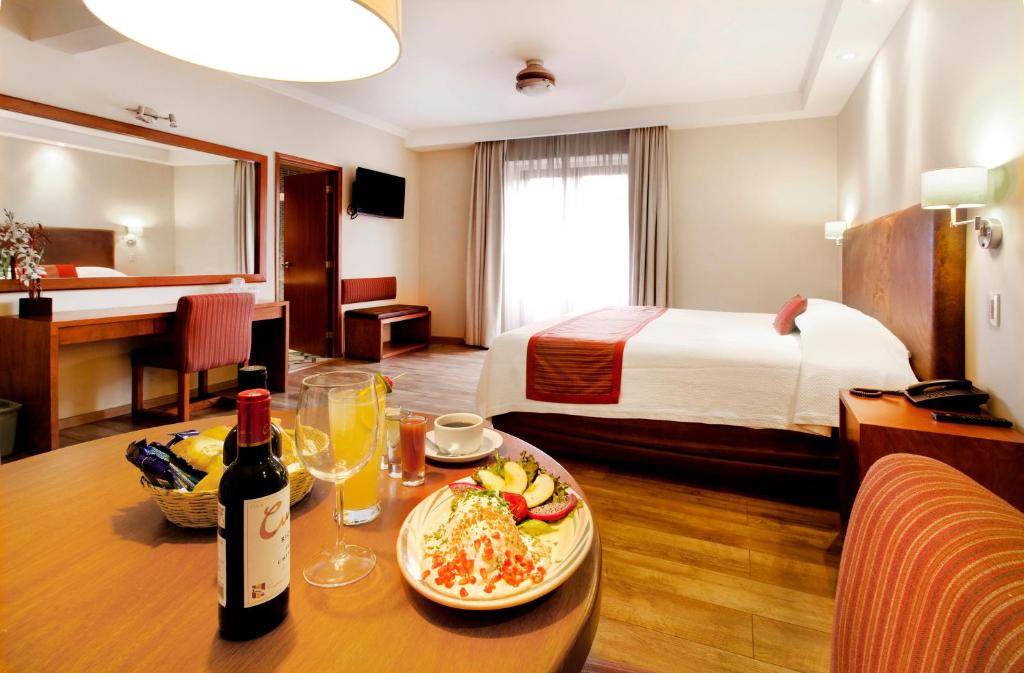 a hotel room with a table with a plate of food at Hotel Gillow in Mexico City