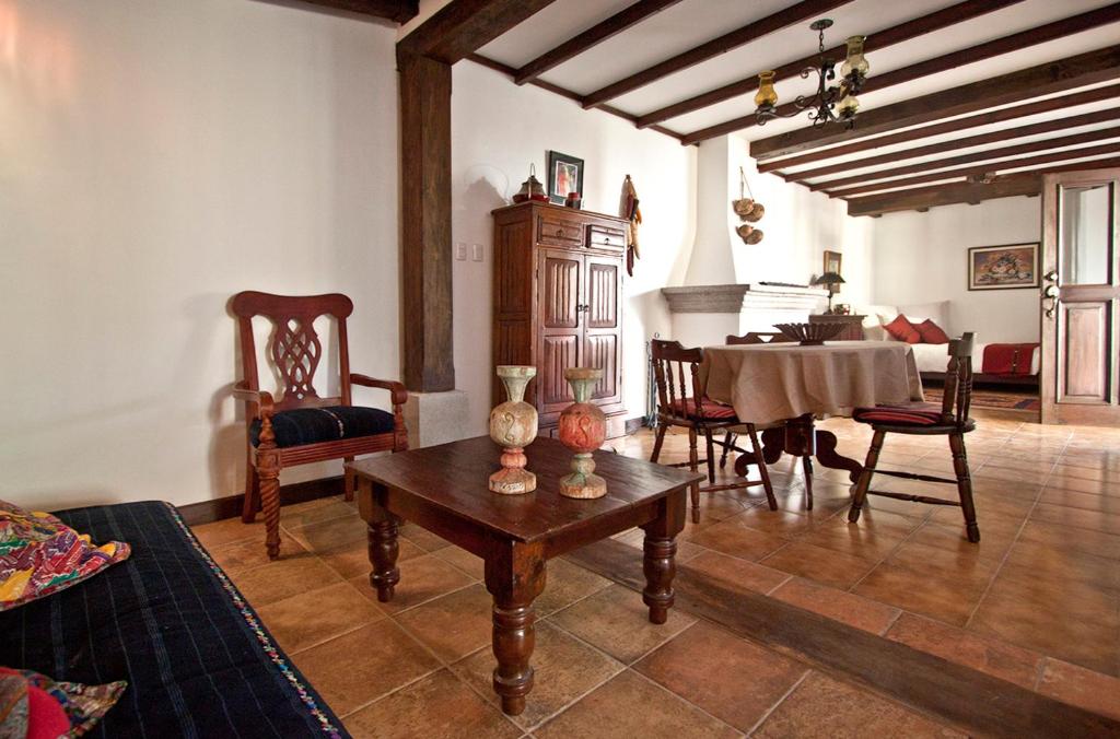 a living room with a table and a dining room at Villas Santa Ana in Antigua Guatemala