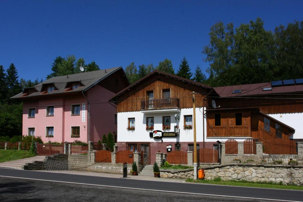 a couple of buildings on the side of the road at Penzion Kozabar in Horní Luby