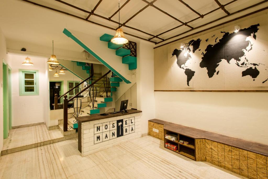 a lobby with a map of the world on the wall at Hostel Mantra in Mumbai