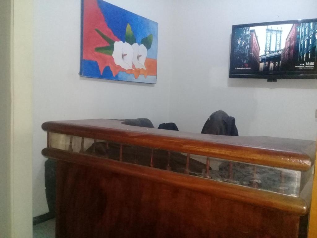 a courtroom with a wooden desk and a painting on the wall at Hostel Residential Inn in Rio de Janeiro