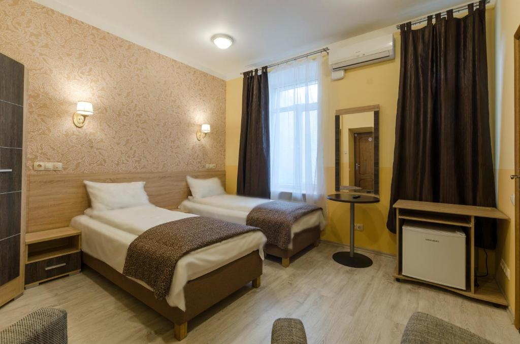 Postel nebo postele na pokoji v ubytování Gogol Park Rooms