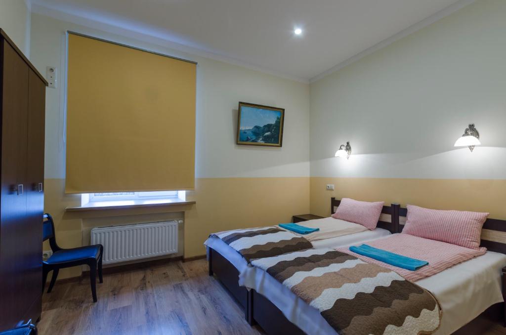 Postel nebo postele na pokoji v ubytování Gogol Park Rooms