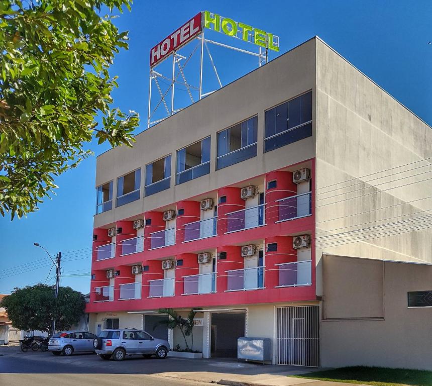 a hotel with a hotel sign on top of it at Golden Hotel in Vilhena