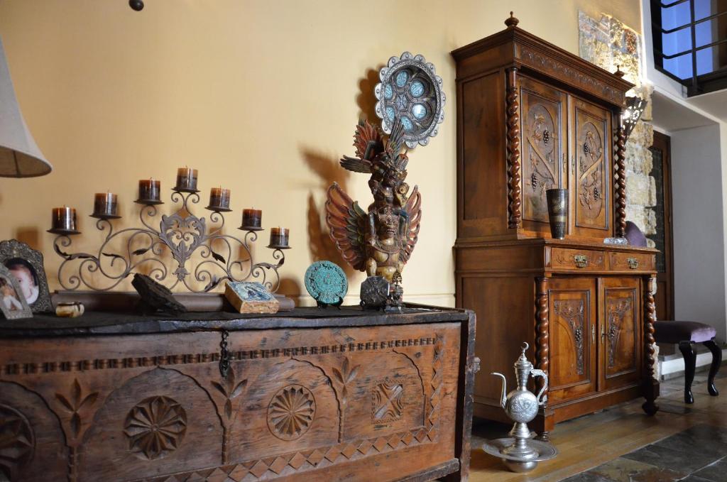 a room with a large wooden dresser next to a wall at Ai Cartari in Palermo