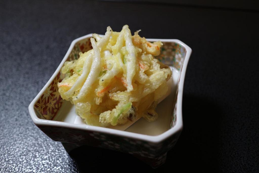 a small container of food sitting on a table at Jizokan Matsuya Ryokan in Nagano