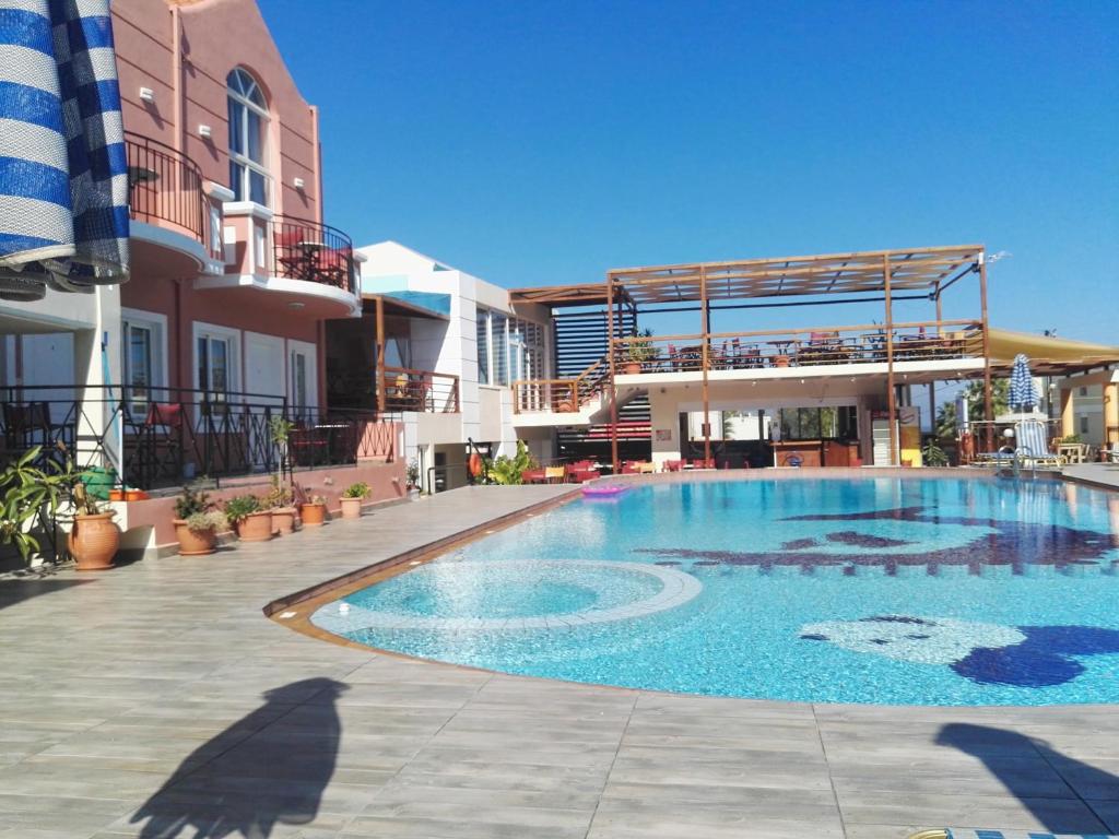 a large swimming pool in front of a large building at Epis Hotel in Agia Marina Nea Kydonias