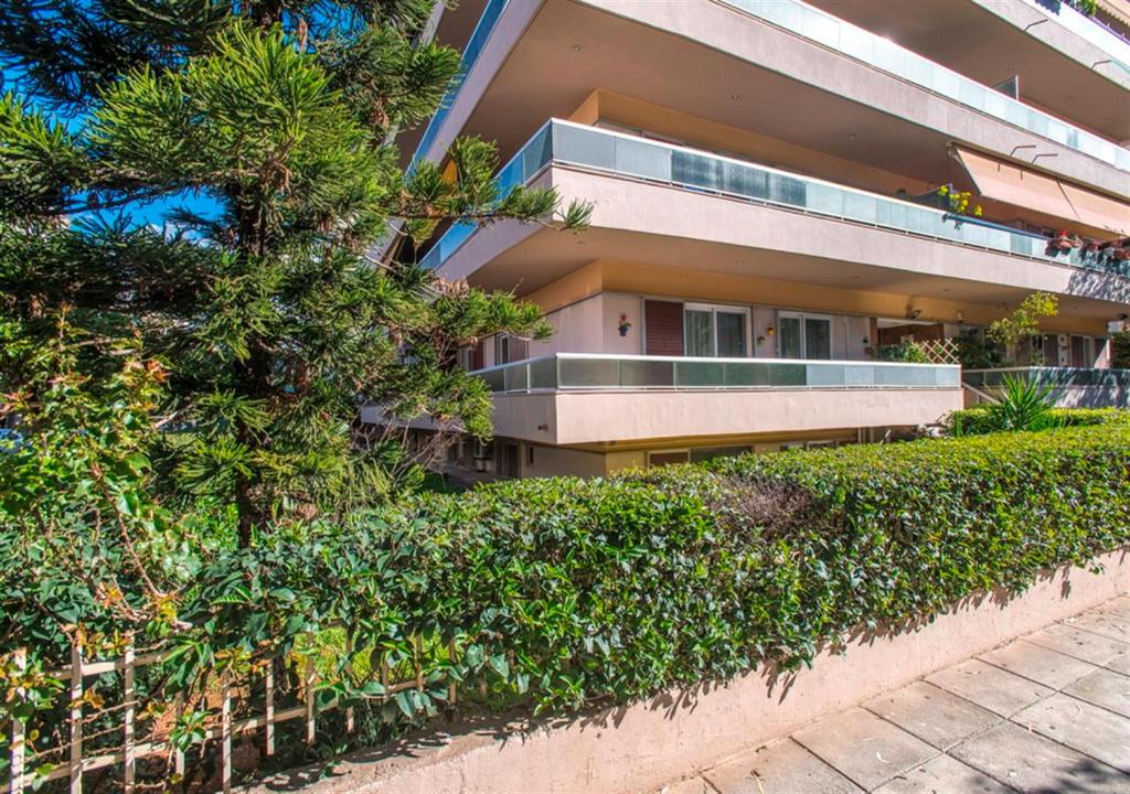 apartamentowiec z krzakami przed nim w obiekcie Athena's Comet w Atenach