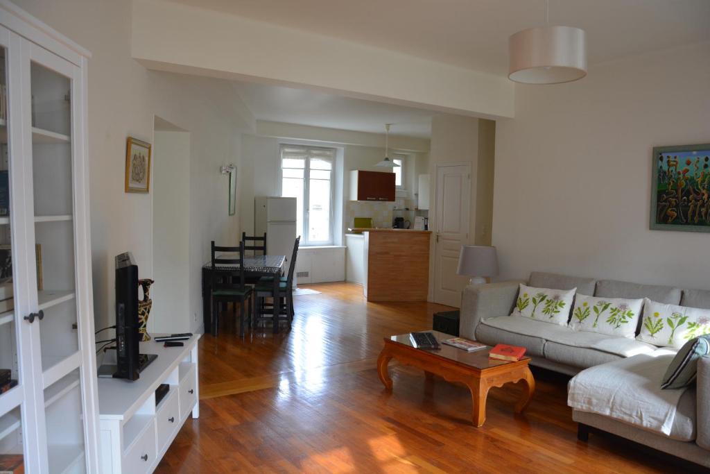 a living room with a couch and a table at Jacques MELCHIOR meublé de tourisme 3 étoiles Intra Muros in Saint Malo