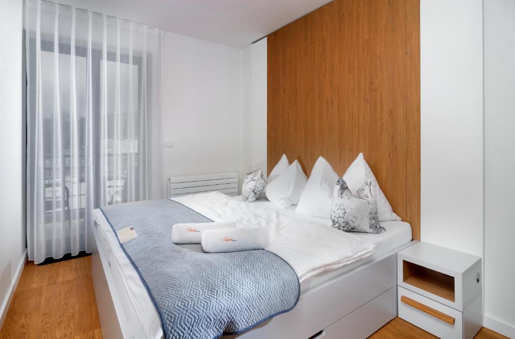 Postel nebo postele na pokoji v ubytování Apartments Residence Grand