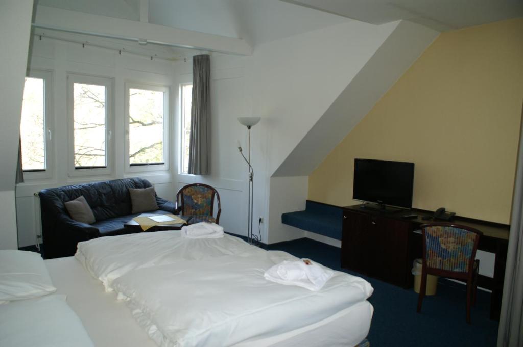 Postel nebo postele na pokoji v ubytování Hotel Strandpavillon