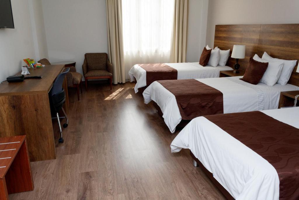 Postel nebo postele na pokoji v ubytování Hotel Nutibara