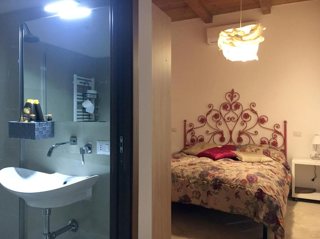 a bathroom with a bed and a sink next to a shower at Villa Masullo in Mercogliano