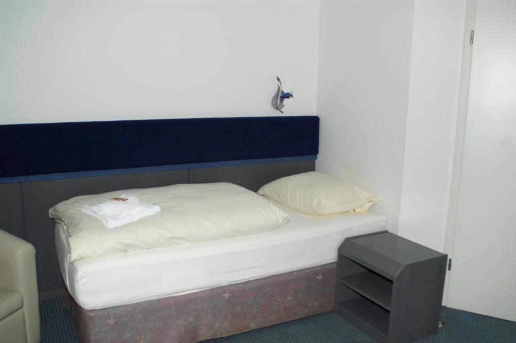 Postel nebo postele na pokoji v ubytování Hotel Strandpavillon