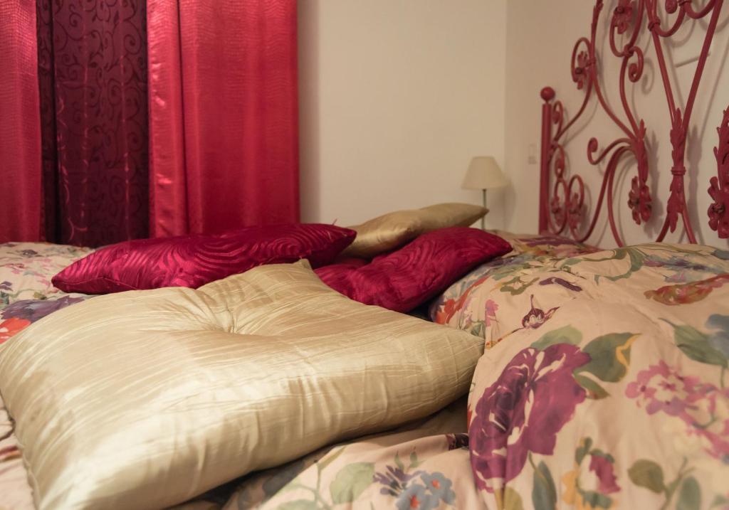 a bedroom with two beds with red pillows at Villa Masullo in Mercogliano
