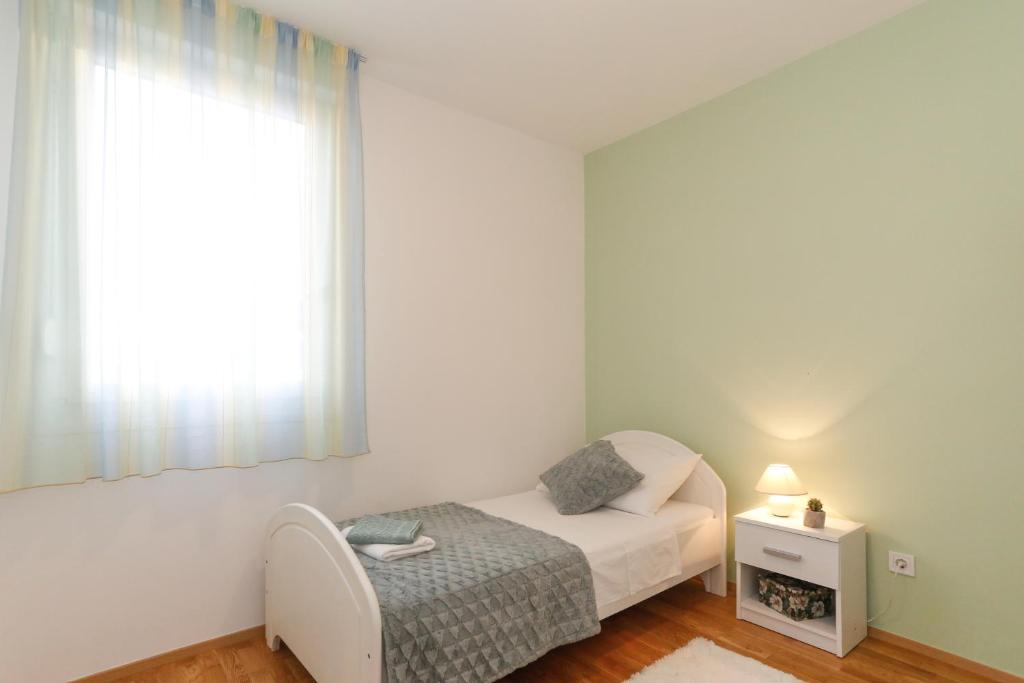 Postel nebo postele na pokoji v ubytování Apartment Miki