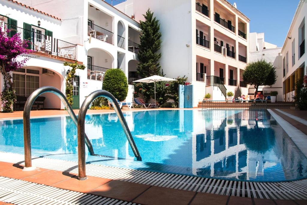 a swimming pool in the middle of a building at Can Digus in Fornells